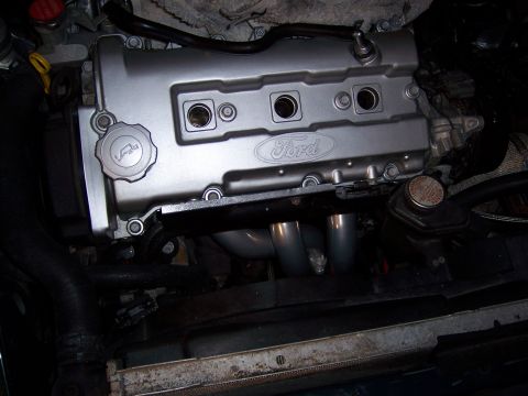 1997 Ford Probe - Close-up of a Ford engine, showing the silver valve cover and exhaust headers.