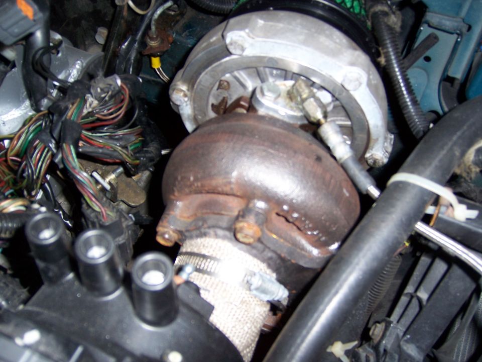 close-up of turbocharger with wiring and hoses