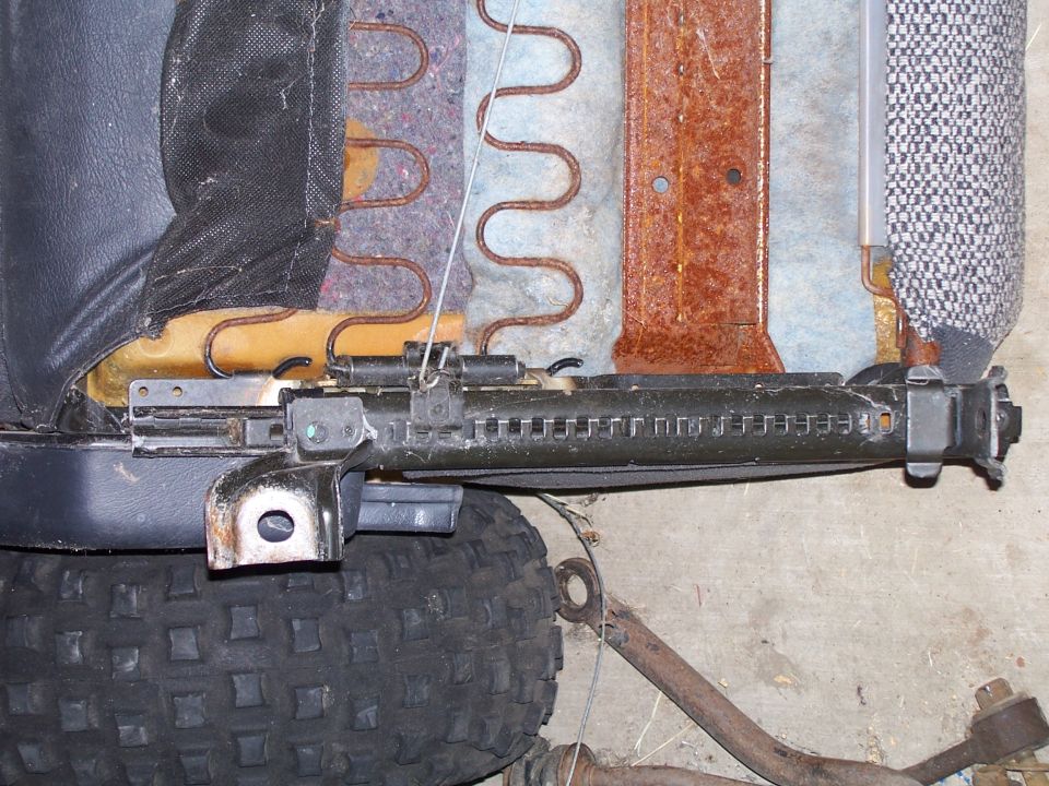 Close-up of a vehicle seat's metal adjustment mechanism and springs