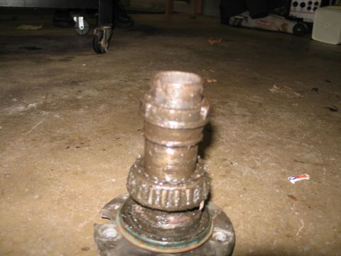 1995 Ford Bronco - A close-up view of a used wheel bearing assembly, showing wear on the roller bearings and threaded spindle.