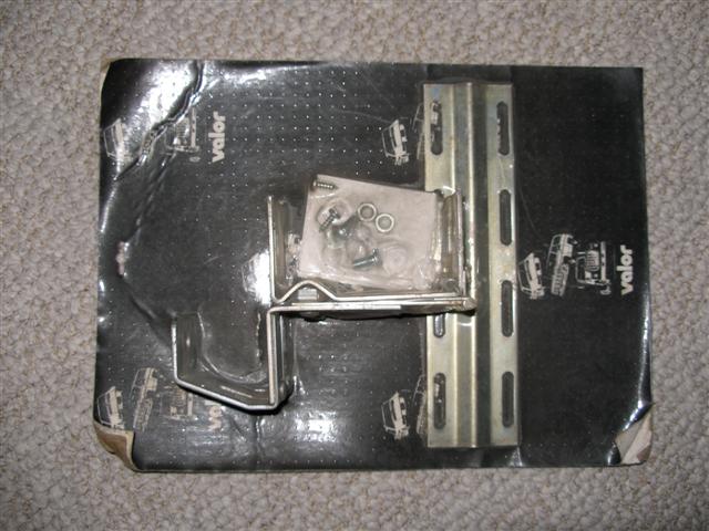 Chrome bracket hardware and mounting strip on Valor packaging sitting on carpet