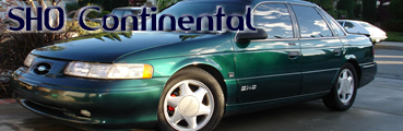 1993 Ford Taurus - 1993 Ford Taurus SHO sedan in green, seen from the front 3/4 angle. Text overlay reads "SHO Continental".