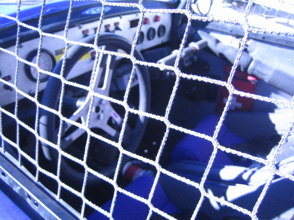 View through a window net into the cockpit of an off-road race car