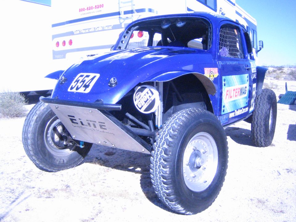 Blue Baja Bug race car number 554 with FilterMag sponsor decals in desert