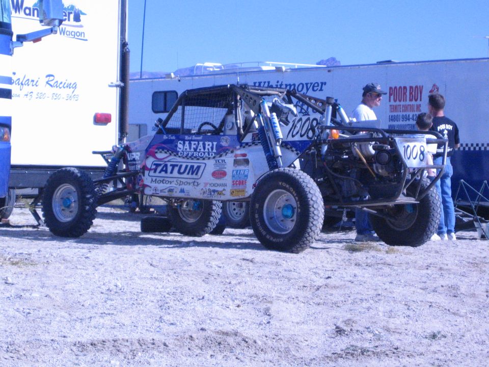 Off-road race buggy number 1008 with Tatum and Safari Offroad sponsor decals in a desert pit