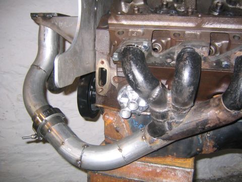 1969 Ford Mustang - Custom exhaust manifold and turbo piping installation on an engine block.