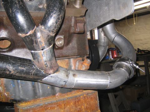 1969 Ford Mustang - Custom turbo exhaust manifold piping and wastegate assembly shown on an engine block.