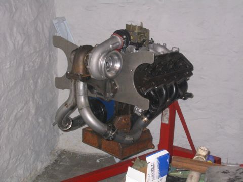 1969 Ford Mustang - Custom turbocharged V8 engine assembly on an engine stand, ready for installation.