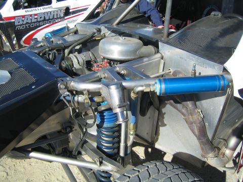 1990 Ford Bronco - Close-up of the rear engine, air cleaner and blue suspension of a Baldwin Motorsports off-road race truck.