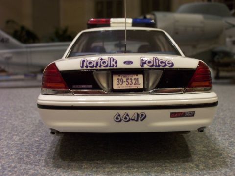 1998 Ford Crown Victoria - Rear view of a 1998 Ford Crown Victoria police car with 'Norfolk Police' text and emergency lights.