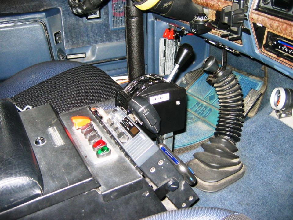 Blue Ford interior showing floor shifters, switch panel and CB radio on center console