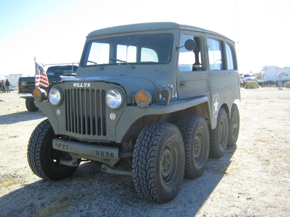 Olive-drab Willys 8-wheeled vehicle with round headlights and white star