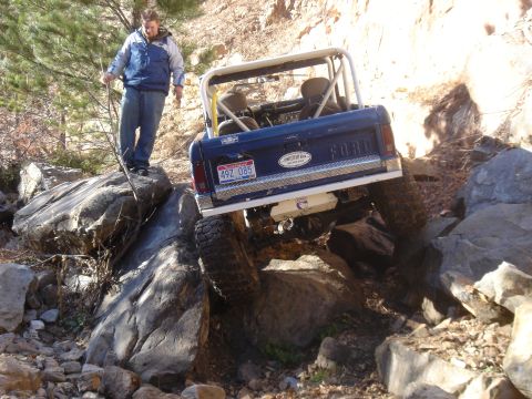 1977 Ford Bronco - This 1977 Ford Bronco is tackling a challenging off-road course with large rocks.