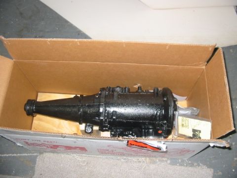 1985 Ford Crown Victoria LTD - A black automatic transmission is shown inside its shipping box, resting on wooden supports.