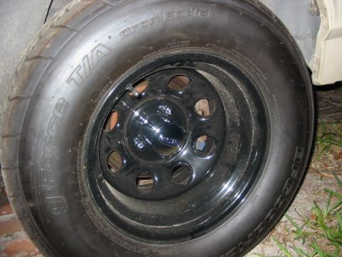 1985 Ford LTD Crown Victoria - Close-up of a drag radial tire mounted on a black steel wheel.