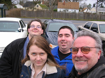 1999 Ford Crown Victoria - A group of four people are photographed with several cars in the background.