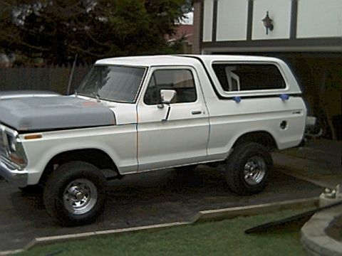 1978 Ford Bronco - This 1978 Ford Bronco is parked in front of a house with a garage.