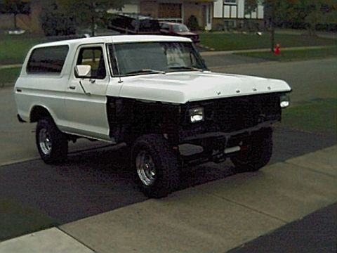 1978 Ford Bronco - White 1978 Ford Bronco parked on a driveway, front grille removed.