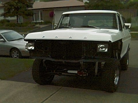 1978 Ford Bronco - Front view of a white 1978 Ford Bronco, showing its distinctive body style and missing grille.
