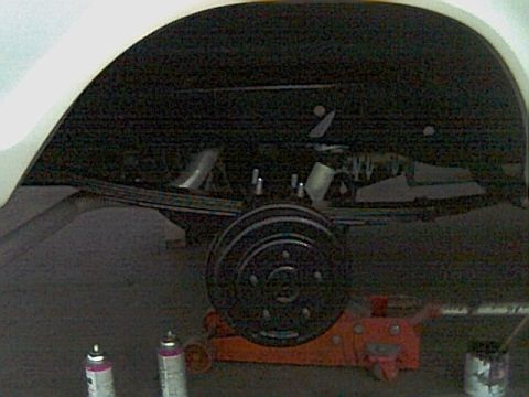 1978 Ford Bronco - Close-up of the rear suspension and axle of a 1978 Ford Bronco, showing leaf springs and a drum brake.