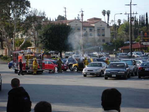 1993 Ford Taurus - Firefighters respond to a vehicle fire in a crowded parking lot.