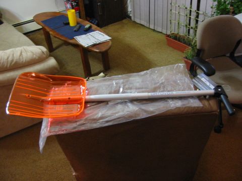 1996 Ford Bronco - Orange snow shovel with white handle labeled ORTOVOX is shown indoors.