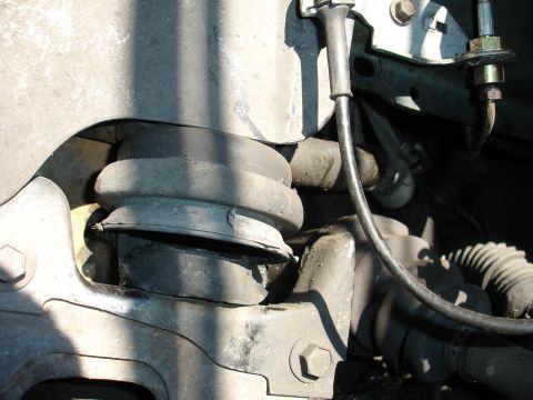 1993 Ford Taurus - Close-up of a worn suspension part, showing damage to the rubber and surrounding metal components.