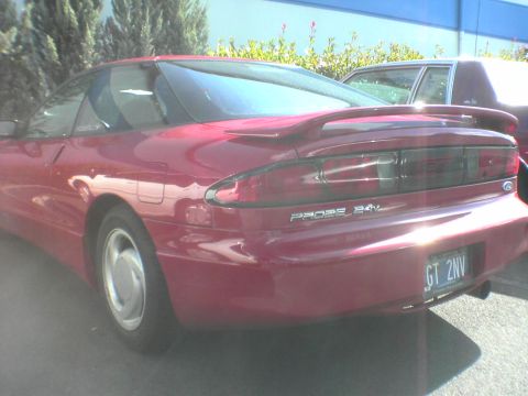 1996 Ford Probe - Rear view of a red 1996 Ford Probe GT 24V, showing its distinctive taillights and spoiler.
