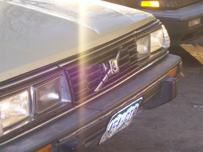 1972 Ford Ranchero - A tan car's front end is shown, with another vehicle visible behind it.