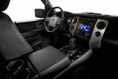 1991 Ford LTD Crown Victoria - The interior of a modern vehicle shows a dashboard with a navigation screen and leather seats.