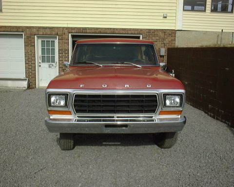 1978 Ford Bronco - Front view of a red 1978 Ford Bronco parked in front of a building.