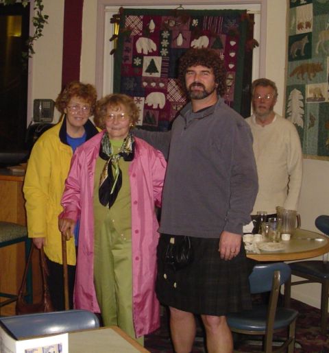 1990 Ford Bronco - A group of four people are gathered indoors, with decorative quilts displayed on the wall behind them.