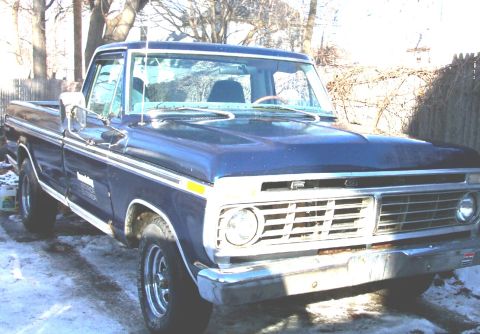 1975 Ford F-150 - This blue 1975 Ford F-150 pickup truck is shown from a three-quarter front view.