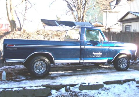 1975 Ford F-150 - A blue Ford pickup truck is parked outside in the snow. The truck has a "Ranger XLT" badge on the fender.