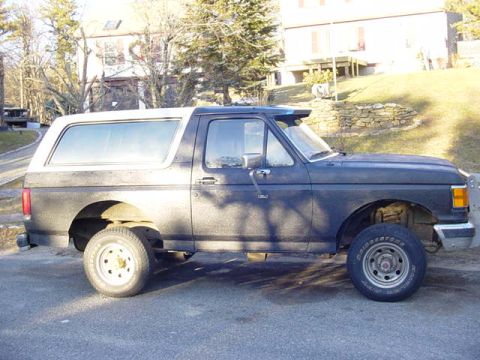 1989 Ford Bronco - This 1989 Ford Bronco is shown from the side, a two-tone paint scheme with a white top.