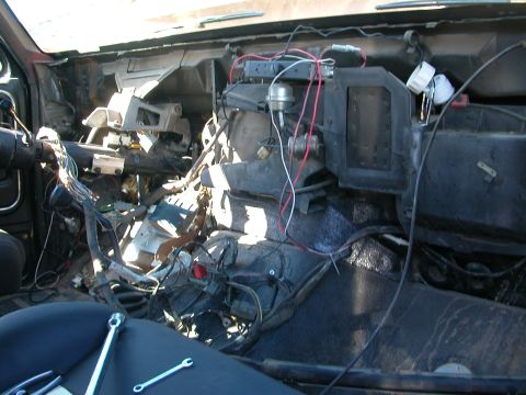 1984 Ford Bronco - Interior view of a vehicle's dashboard with wiring harness exposed, suggesting repair or modification work.