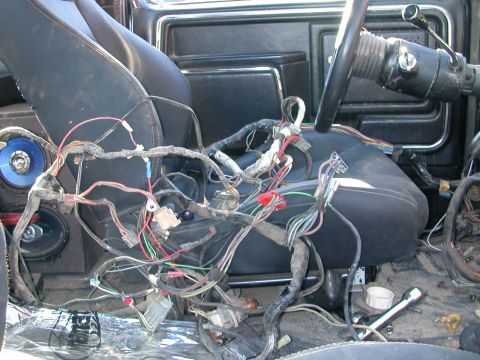 1984 Ford Bronco - Exposed wiring harness in the interior of a 1984 Ford Bronco, likely during a repair or modification.