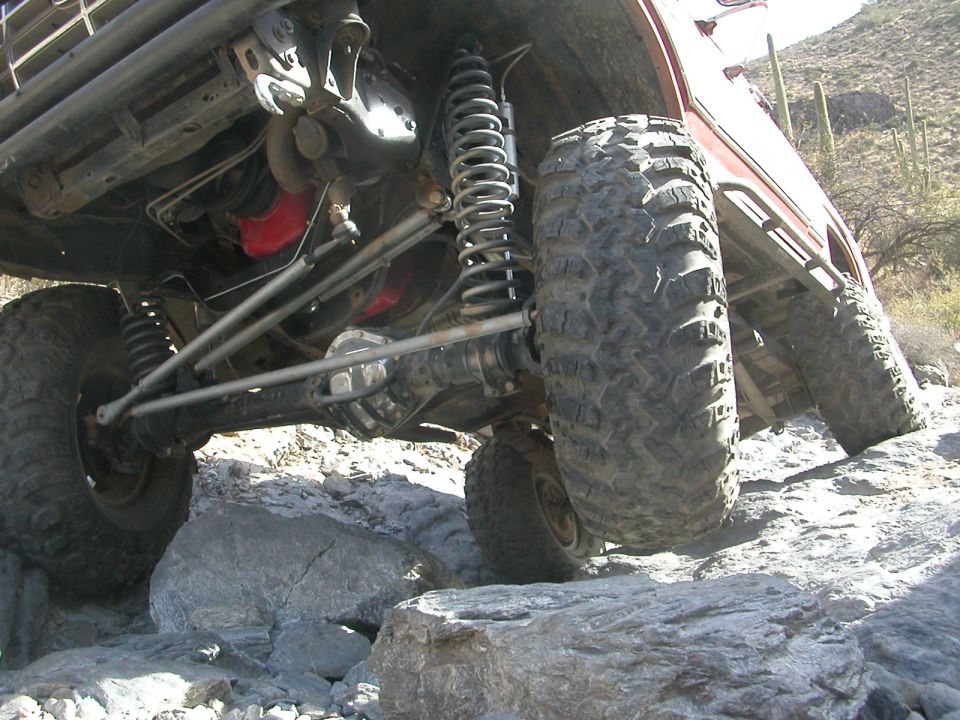 1984 Ford Bronco front suspension and drivetrain on rocks