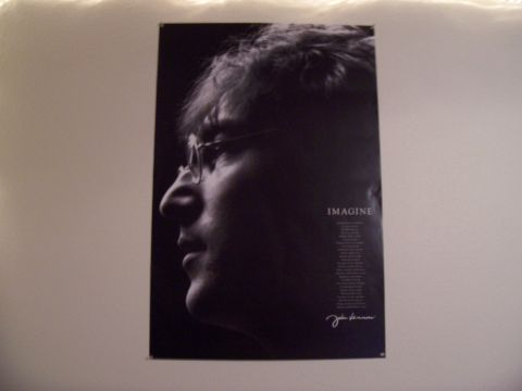 2004 Aston Martin Virage - A black and white poster of John Lennon's profile is displayed on a wall.