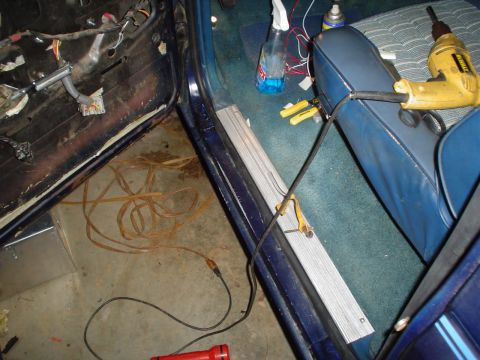 1984 Ford Bronco - The interior of a vehicle shows exposed wiring and tools, suggesting ongoing work or repair.