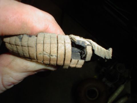1984 Ford Bronco - A hand holds a damaged interior trim piece with visible tape and cut sections.