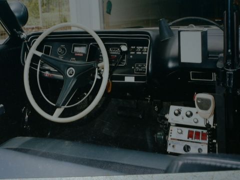 1991 Ford Crown Victoria - The dashboard and center console of a police vehicle are visible, equipped with communication gear.
