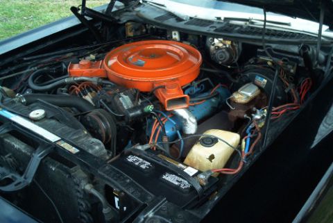 1991 Ford LTD Crown Victoria - Open engine compartment showing a V8 engine with a large orange round air cleaner, plug wires, and accessory components.