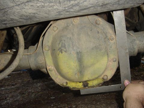 1989 Ford Bronco - A close-up view of a vehicle's rear differential housing, with a ruler for scale.