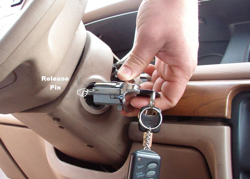 This is what the probe pressed in to release the cylinder.  When the key is rotated, the pin will be forced back out.  The key must be in RUN and the pin pushed in before the cylinder can be re-installed.  Some later cylinders have a rounded spring-loaded pin that won't stay in, but the key still has to be in RUN.