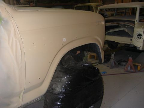 1984 Ford Bronco - A vehicle is being prepped for paint in a workshop, with another vehicle in the background.