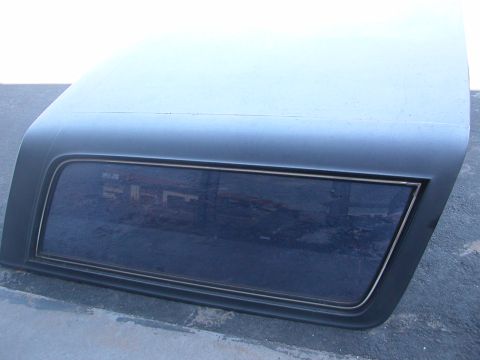 1984 Ford Bronco - This is a detached vehicle hardtop, likely a replacement part, with a tinted rear window.