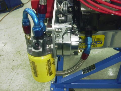 1990 Ford Mustang - Close-up of an engine's oil filter and alternator assembly, braided hoses and custom fittings.