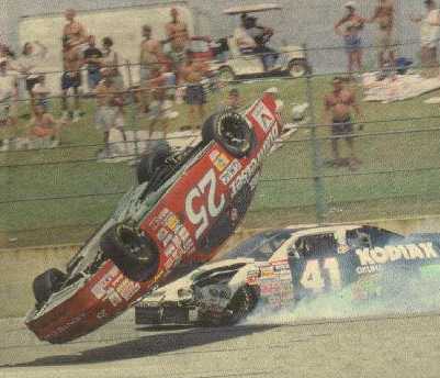 1978 Ford Mustang II - Stock car race incident with one car overturned and another smoking.