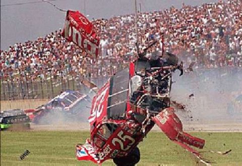 1978 Ford Mustang II - A catastrophic crash at a race track sends debris flying and a car flipping, with a large crowd in the background.